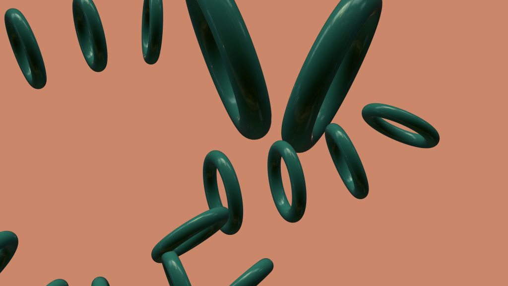 Mehrere dunkle, ringförmige 3D-Objekte schweben vor einem beigen Hintergrund und bilden eine abstrakte, moderne Komposition.